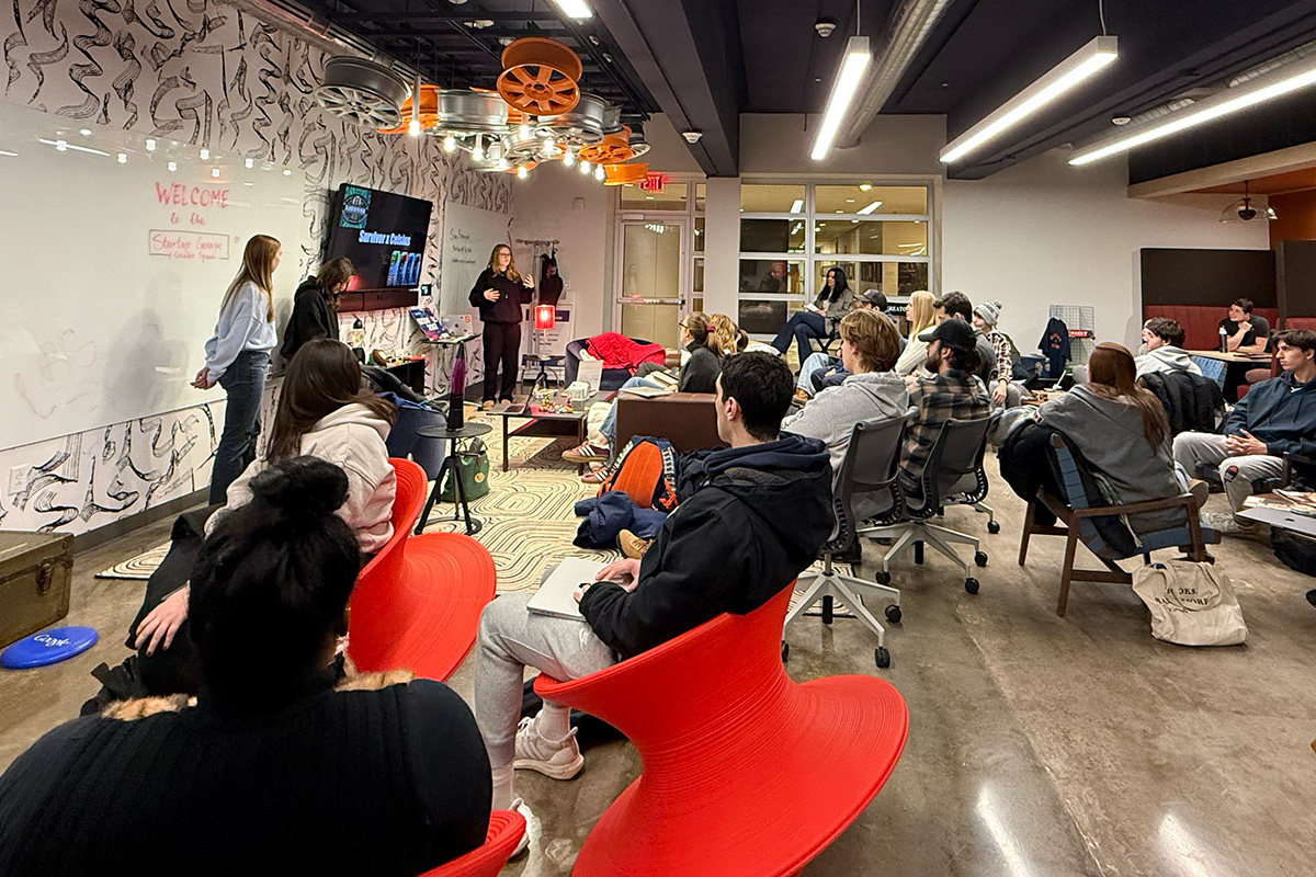 Startup Garage at the Newhouse School with students sitting in the room listening to the professor.