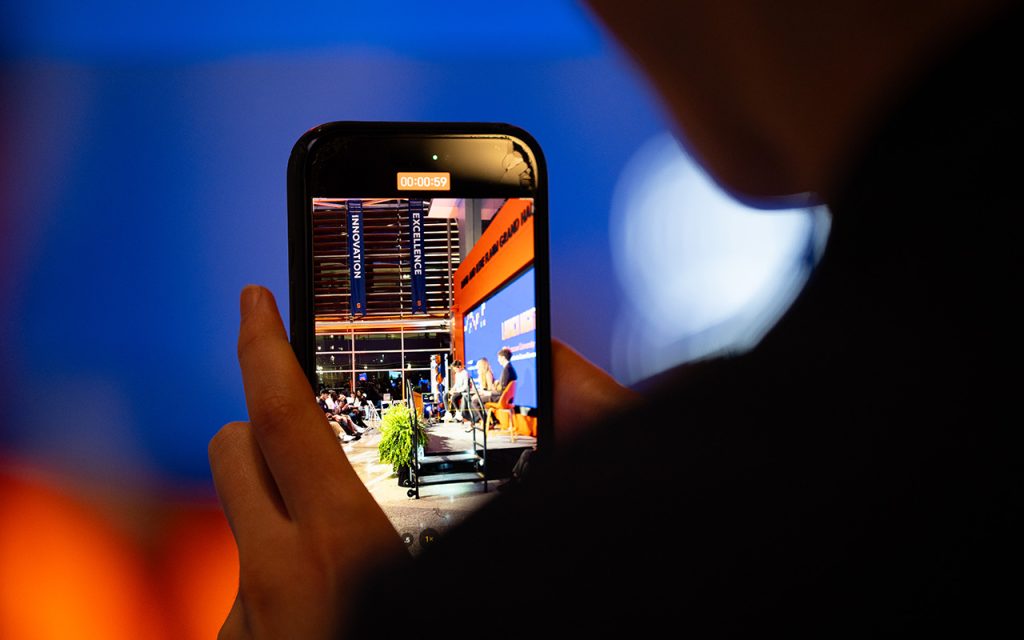 The Center for the Creator Economy Launch Night event is seen through a phone screen while being filmed