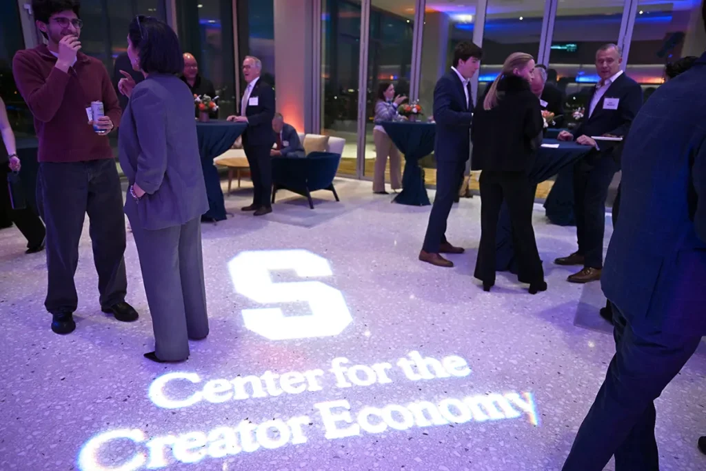 Reception with the Center for the Creator Economy logo projected on the floor