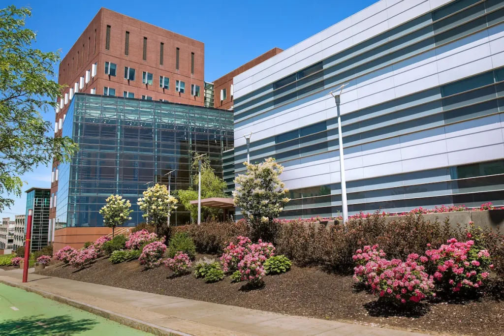 Syracuse University Whitman campus building surrounded by spring landscaping