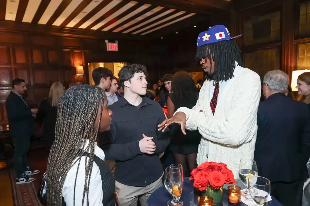 Students mingling with a guest at the NYC launch event.